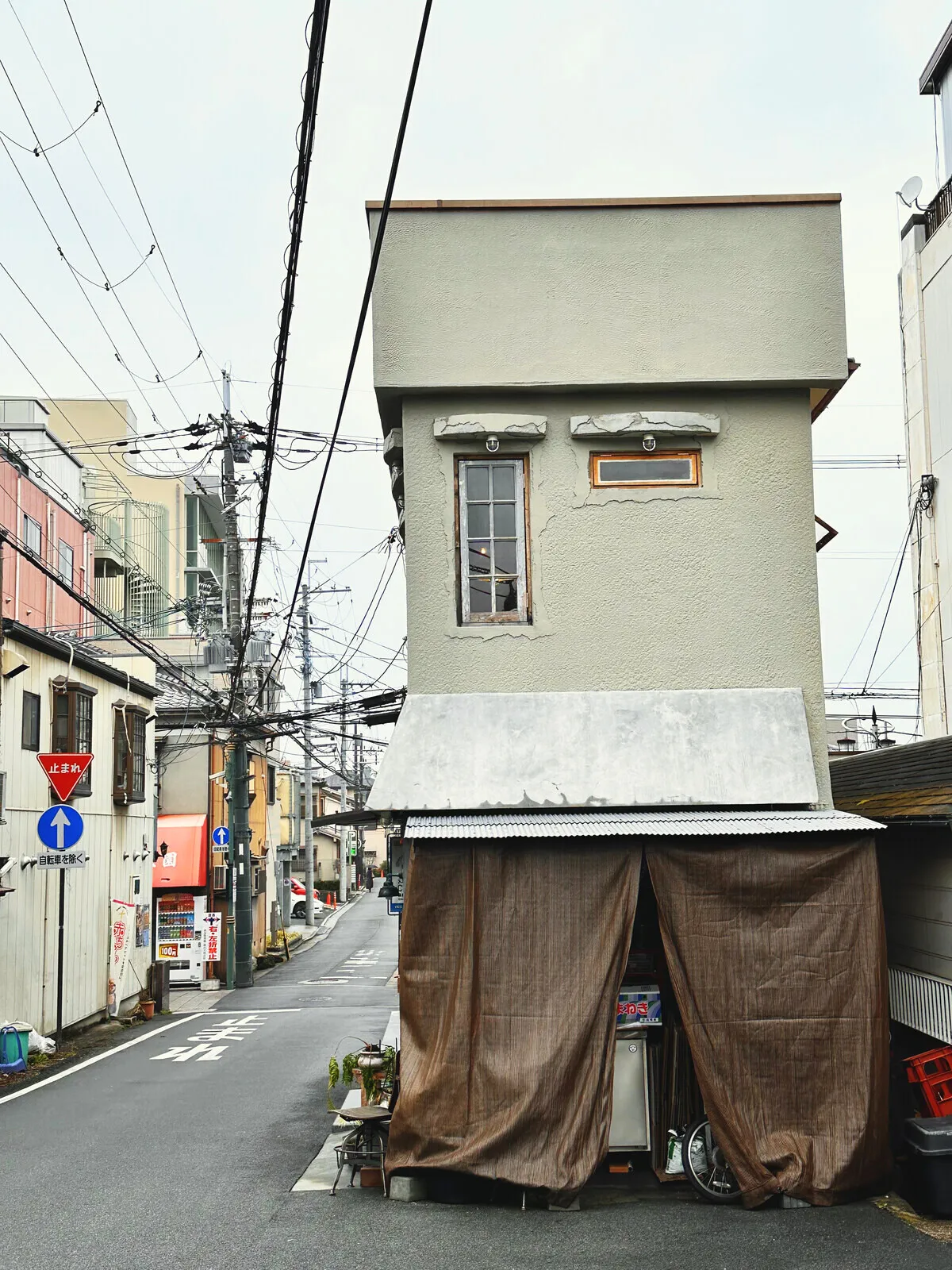 A very narrow house between its neighbours on a street in Nara.