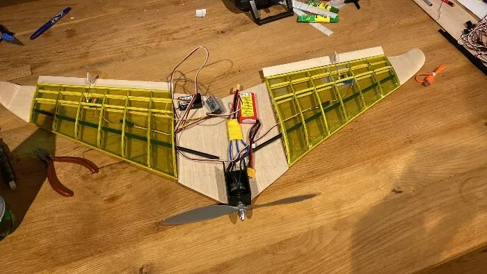 The finished aircraft, covered in green film, with motor, servos and wiring in place.